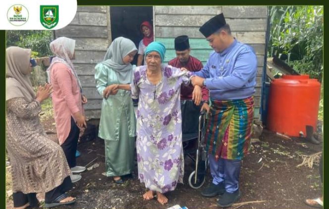 
 Pj. Kades Prapat Tunggal Dodi Islami S. STP MSI saat menyerah kan bantuan kursi roda