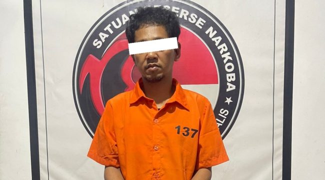 📸 Tersangka pengedar sabu berinisial AT (43) saat diamankan di Mapolres Bengkalis beserta barang bukti narkotika. DOK: HUMAS POLRES BENGKALIS